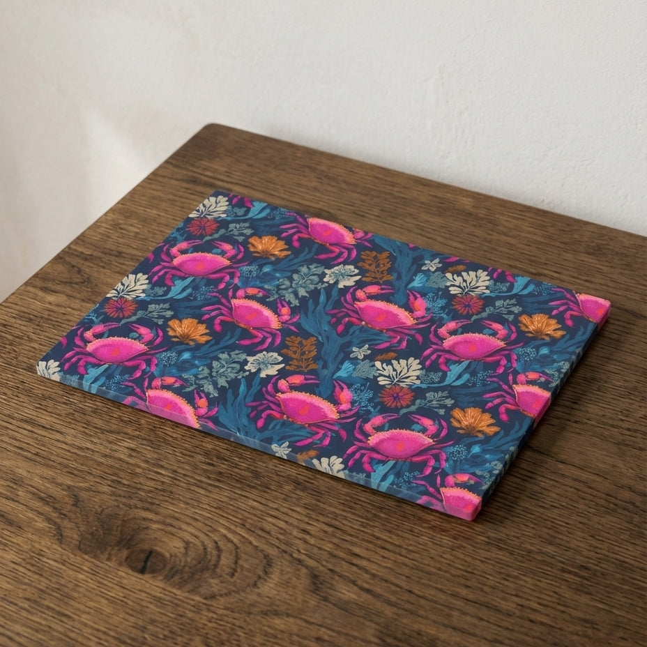 Placemat with pink crab pattern on a wooden surface