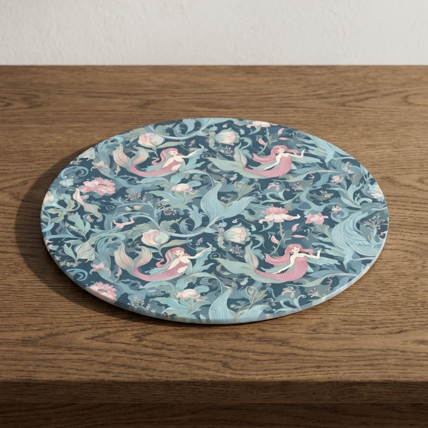 Round board with mermaid design on a wooden surface