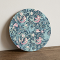 Round decorative board with mermaid pattern on a wooden surface
